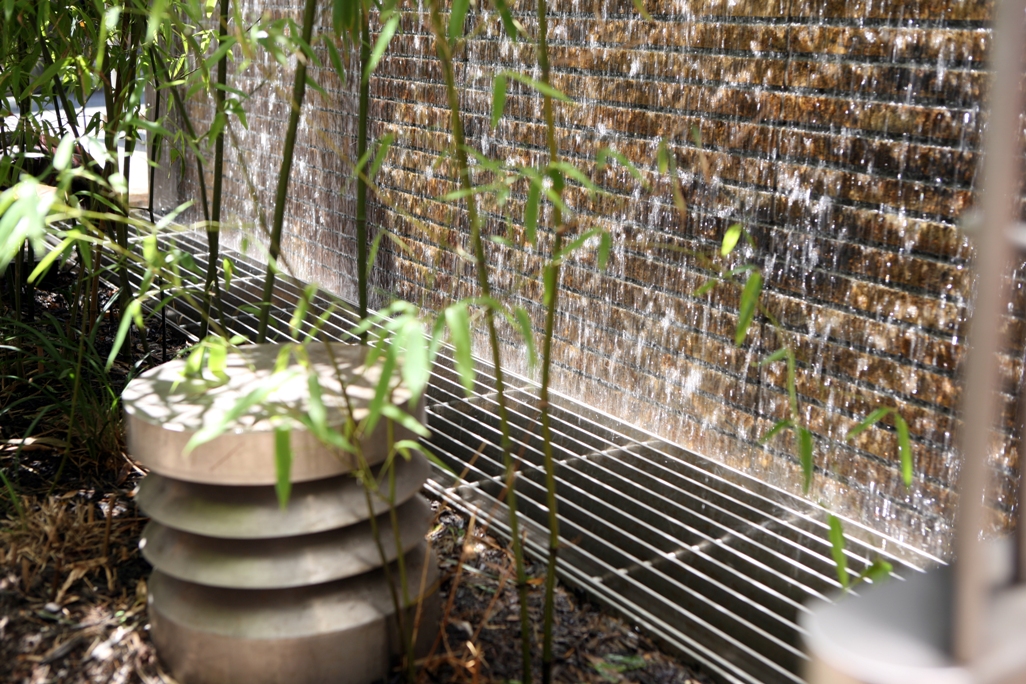 Detail of natural stone water wall at condominium entrance